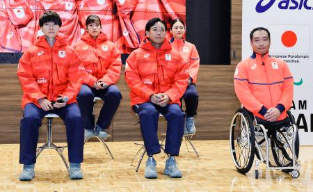 ミラノ・コルティナ冬季五輪・パラリンピックの日本選手団公式スポーツウエアを着用する森重航(手前左)、浮田留衣(奥左)ら=29日、東京都新宿区