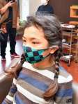 三つ編み姿の田中優成さん