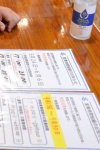時短営業を周知するビラを手元に置く居酒屋の店主。強い移動制限の必要性を感じる