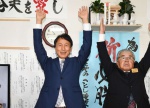 当選確実となり、万歳する三反園訓氏（左）＝３１日午後１０時４４分、鹿児島市谷山中央３丁目
