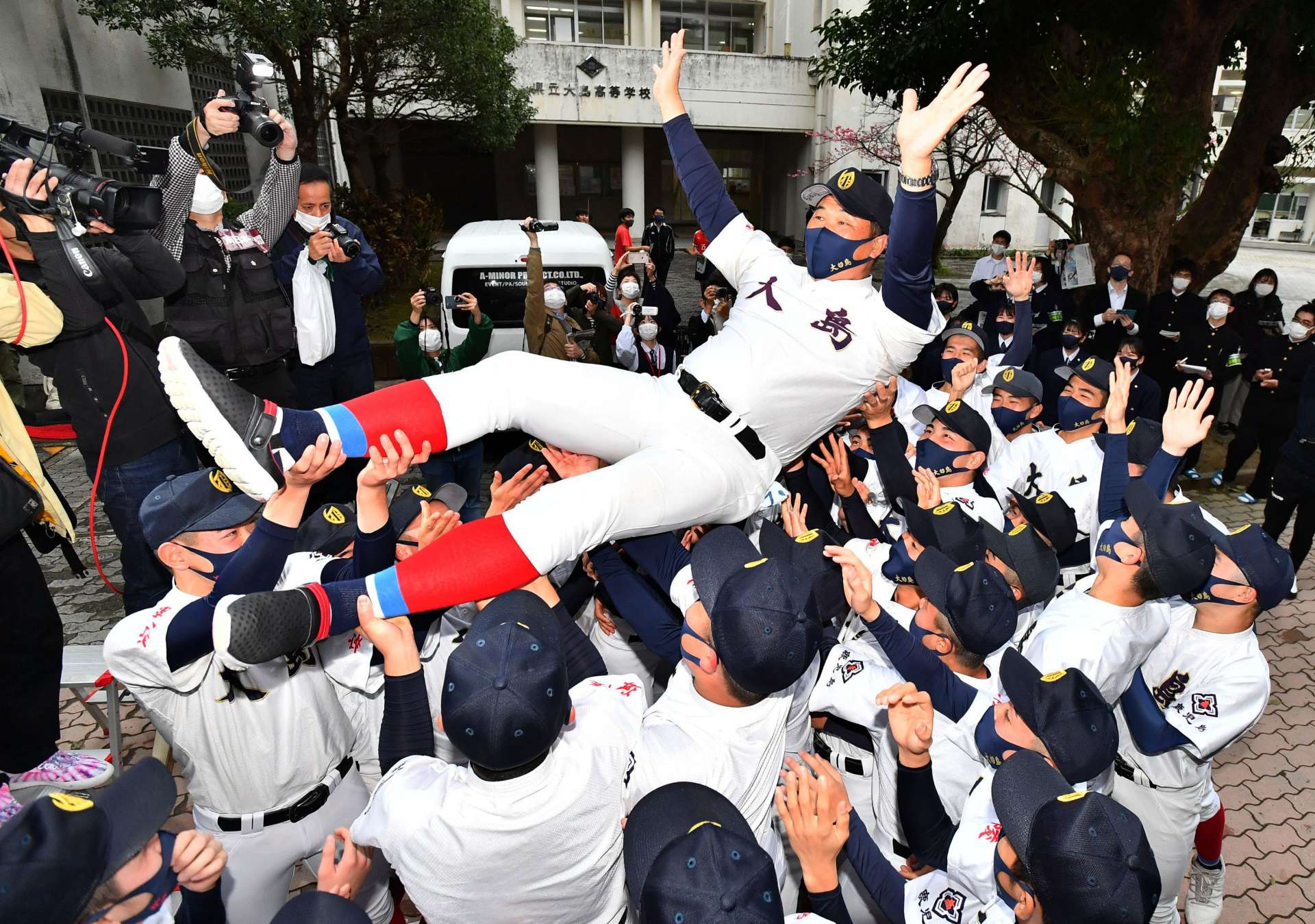 センバツ出場が決まり、塗木哲哉監督を胴上げする大島高校野球部の選手たち＝２８日、奄美市の同校