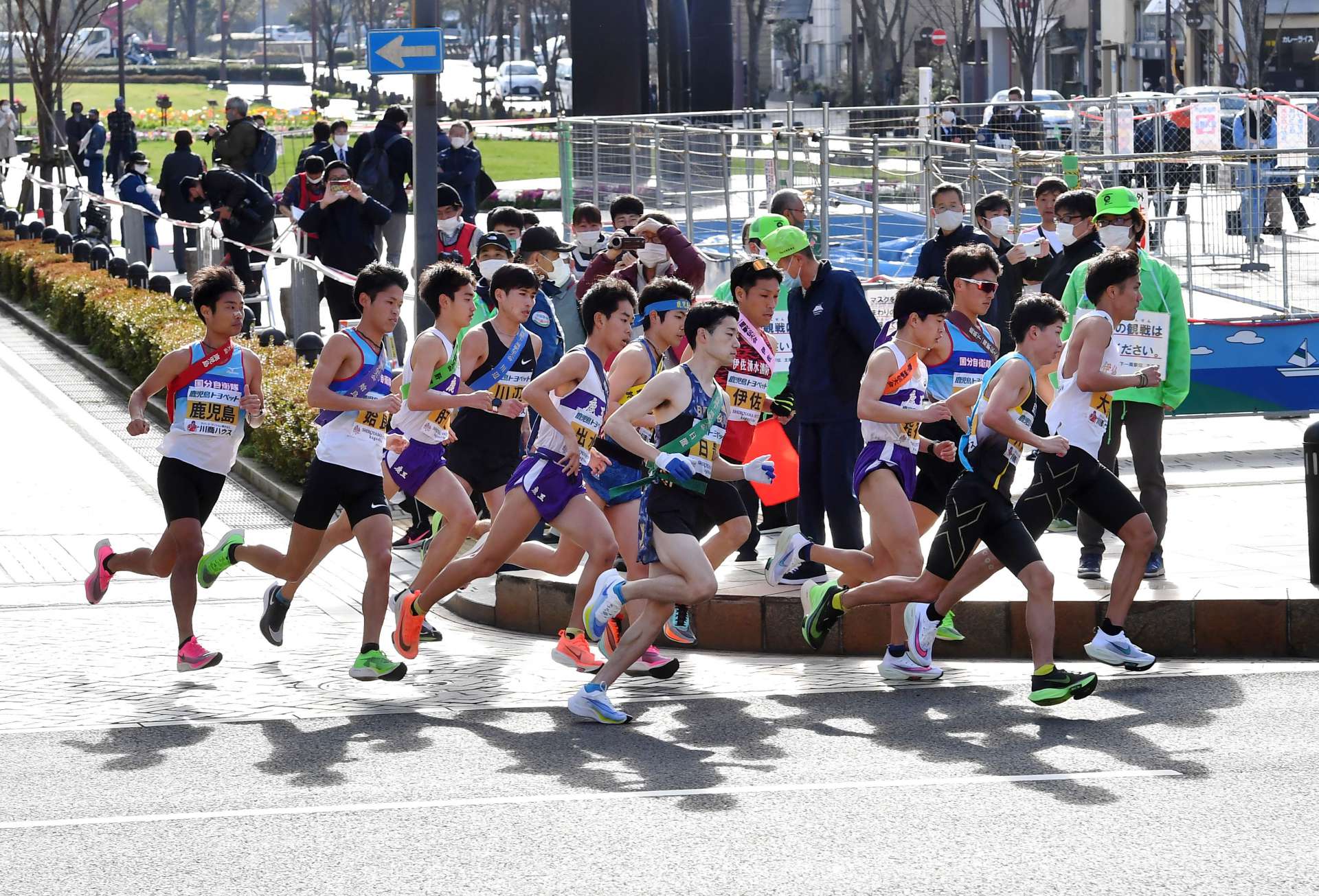 薩摩路へ向け一斉に走り出す１２地区のランナー＝２０２１年２月１３日、鹿児島市のみなと大通り公園