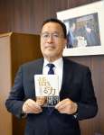 稲盛さんの著書を手にする武隈晃さん＝鹿児島大学
