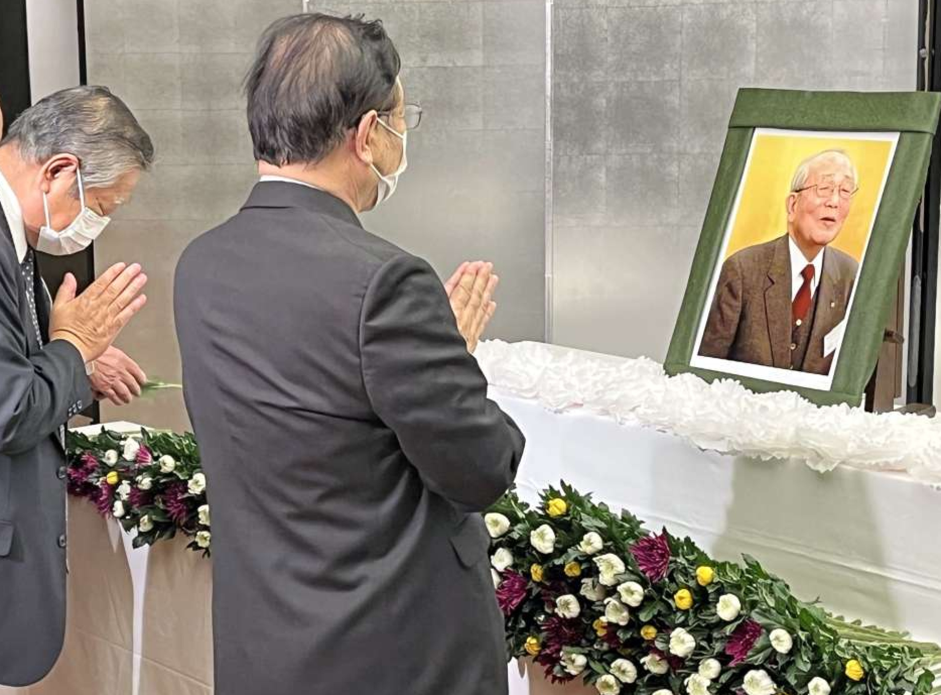 稲盛和夫さんの遺影に献花し、手を合わせる出席者＝京都市
