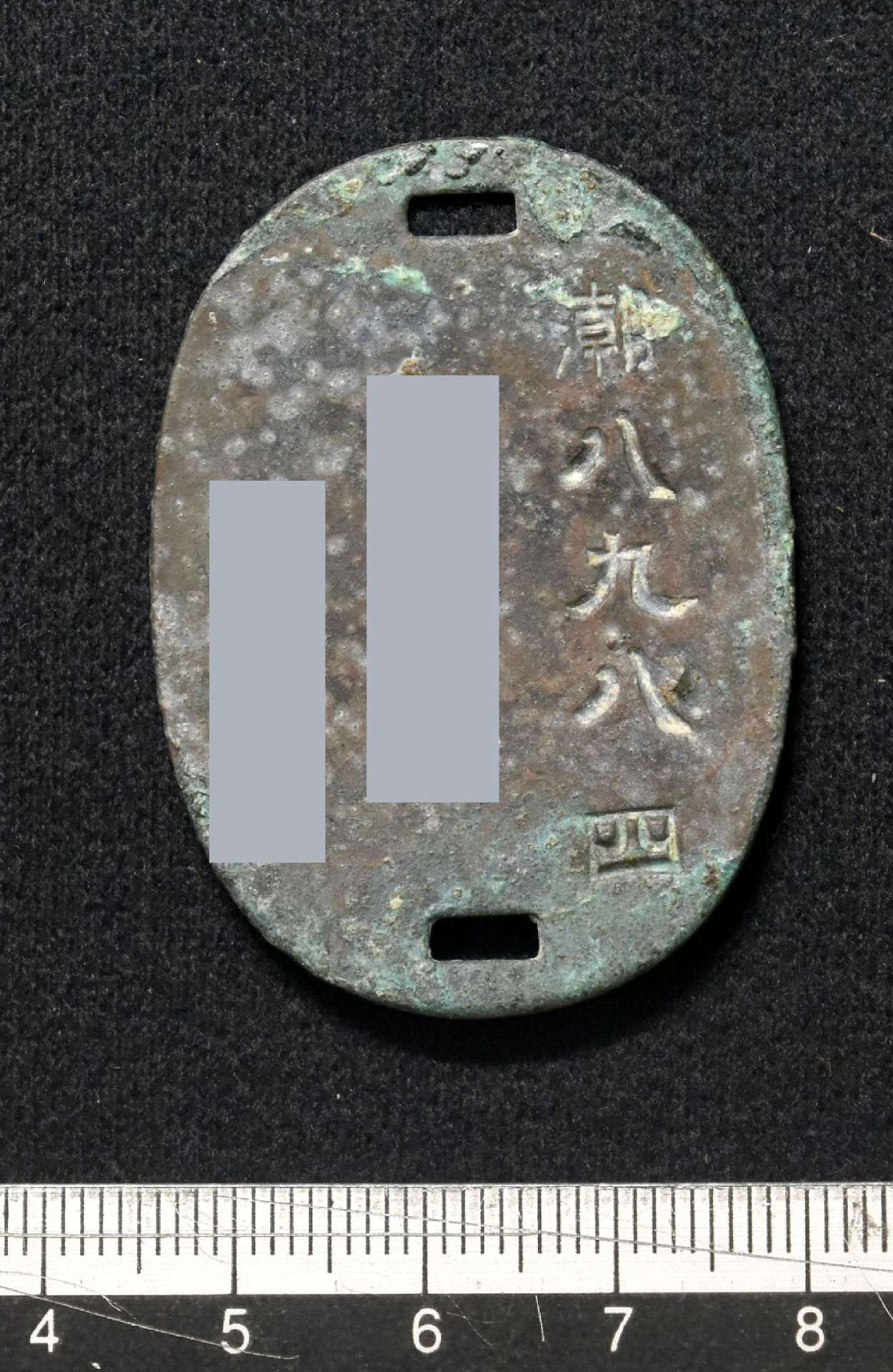 馬毛島で見つかった戦時中の認識票と見られる金属板（西之表市教育委員会提供、画像の一部を加工しています）