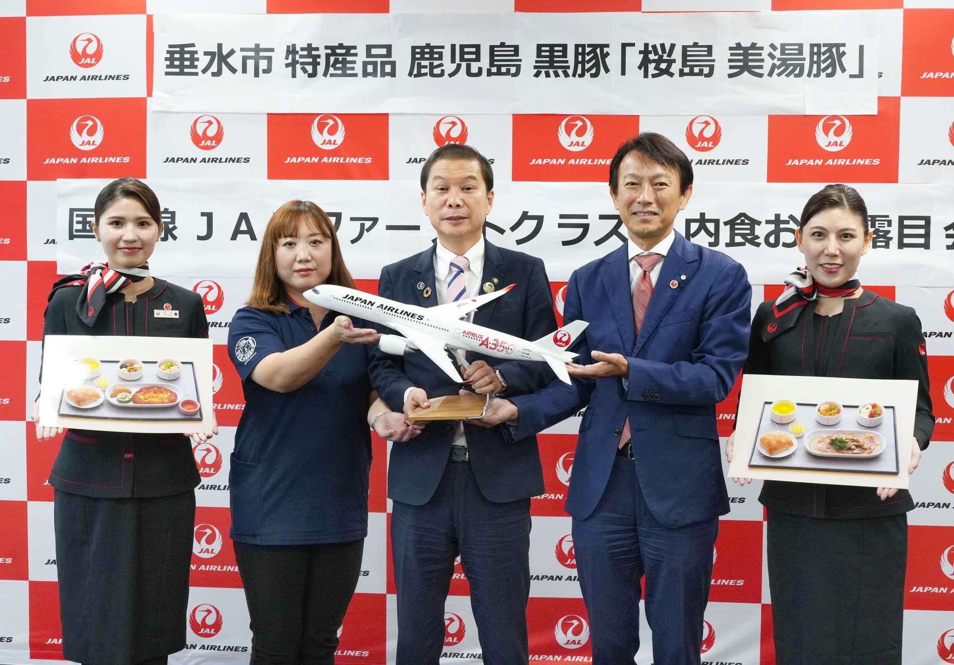 垂水市特産の桜島美湯豚を使った機内食のお披露目会に出席した尾脇雅弥市長（中央）ら＝霧島市の鹿児島空港