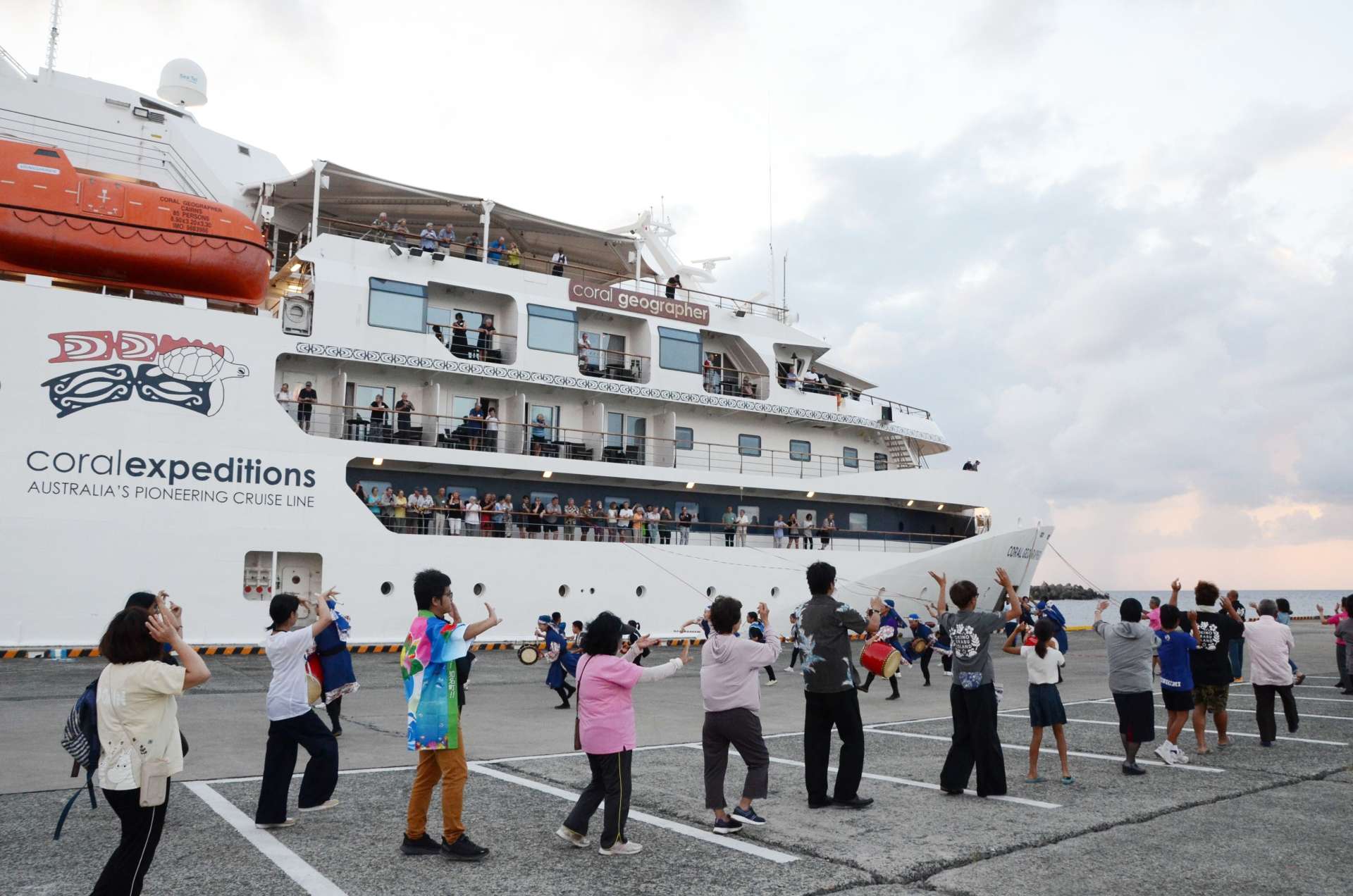 総踊りでクルーズ船を見送る地元住民＝１２日、和泊町の伊延港