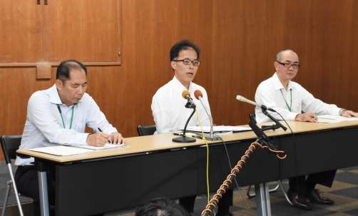 会見で行政処分を発表する指宿市の黒永英樹副市長（中央）＝２２日、指宿市役所