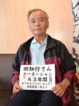 〈関連〉島民からもらったお礼のメッセージを持つ鹿児島市本名町の田知行義久さん＝フェリーとしま２の船内