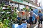 浸水で使えなくなった商品棚を運び出す町民ら＝１０日午後３時２０分ごろ、与論町茶花