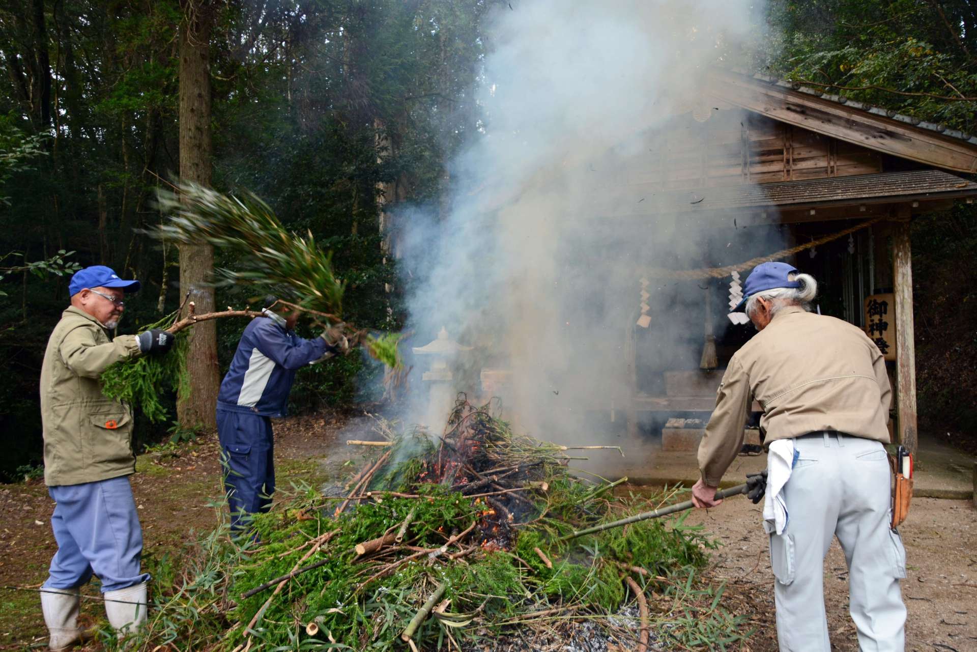 煙を社殿に送る宮田集落の住民＝さつま町泊野