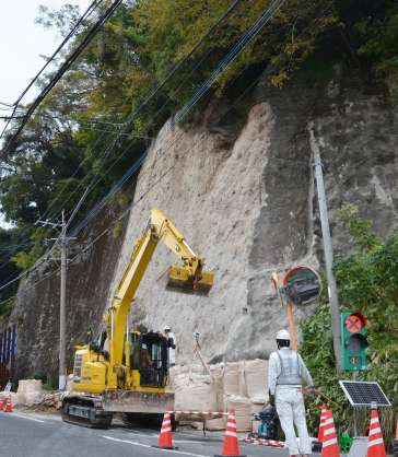 斜面が崩れ、片側通行となっている市道＝６日、鹿児島市武３丁目