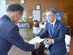 提言書を手渡す中里純人議長（右）＝２３日、いちき串木野市役所