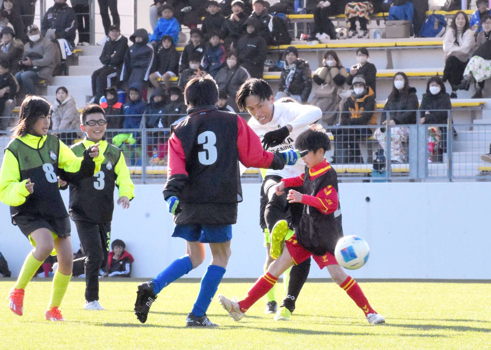 引退試合でシュートを放つ内薗大貴さん（中央）＝指宿市のいぶすきフットボールパーク