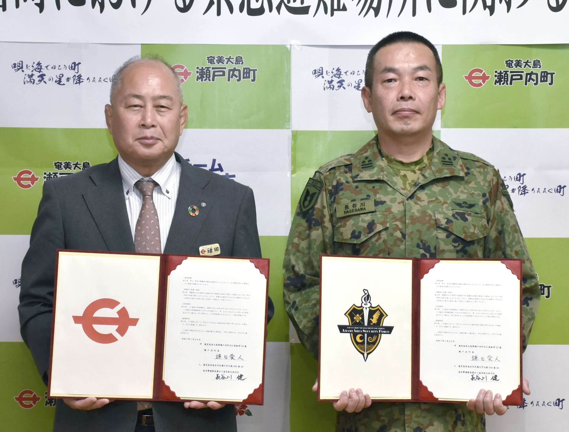 協定を結んだ鎌田愛人町長（左）と長谷川健・奄美警備隊長兼奄美駐屯地司令＝２５日、瀬戸内町役場