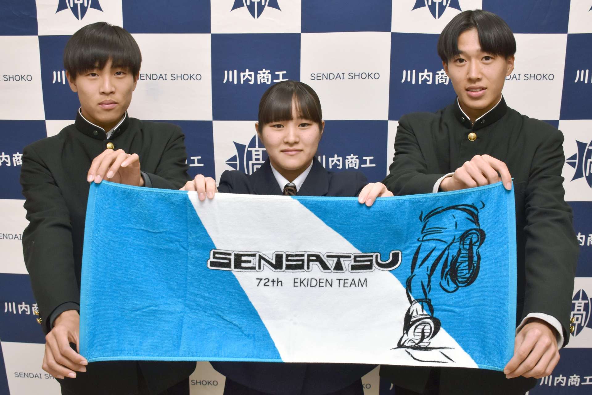 応援タオルのロゴを考案した川内商工高校の岩淵天さん（中央）と、選手の西手新陽さん（左）、上野泰岳さん＝薩摩川内市の同校