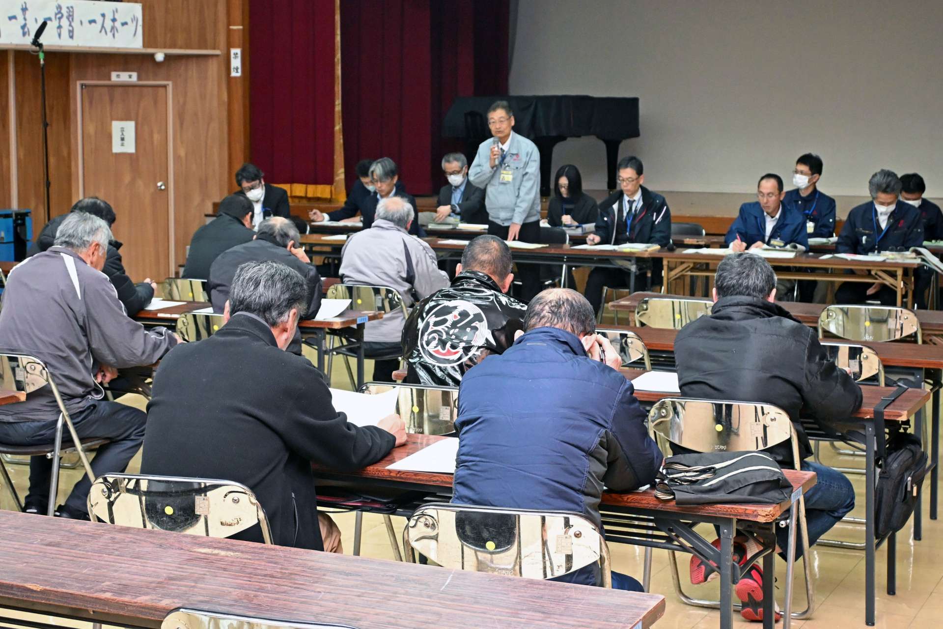 桜島フェリー深夜便廃止についての説明を聞く住民ら＝１３日、鹿児島市の桜島公民館