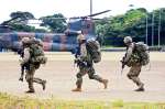 ヘリコプターから降り、戦闘訓練に向かう水陸機動団の隊員＝２７日午後２時、知名町の大山総合グラウンド