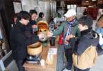 水で割って蒸した焼酎を試飲する参加者＝いちき串木野市の大和桜酒造
