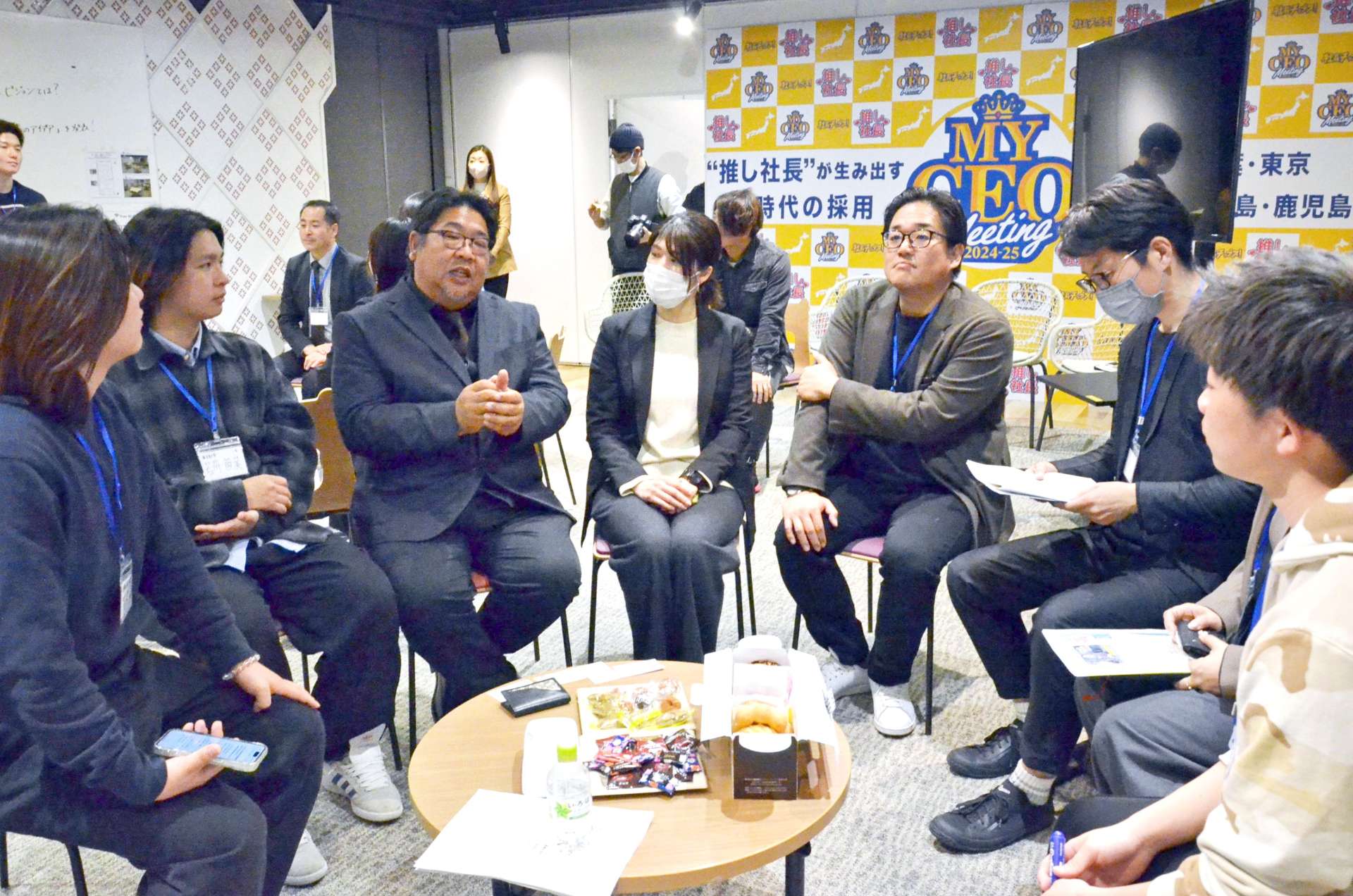 若者が働きたくなるアイデアを学生らと語る西利実社長（左から３人目）＝７日、鹿児島市のマークメイザン