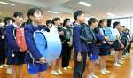 思い出の詰まったランドセルを抱え合唱する６年生＝１７日、鹿児島市の広木小学校