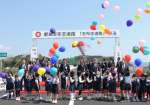 テープカットやくす玉、バルーンリリースで開通を祝う関係者＝２３日、志布志市志布志町安楽