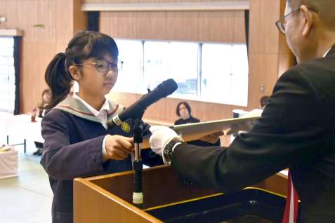 卒業証書を受け取る大原小学校の町優香さん（中央）＝２４日、錦江町田代の同校