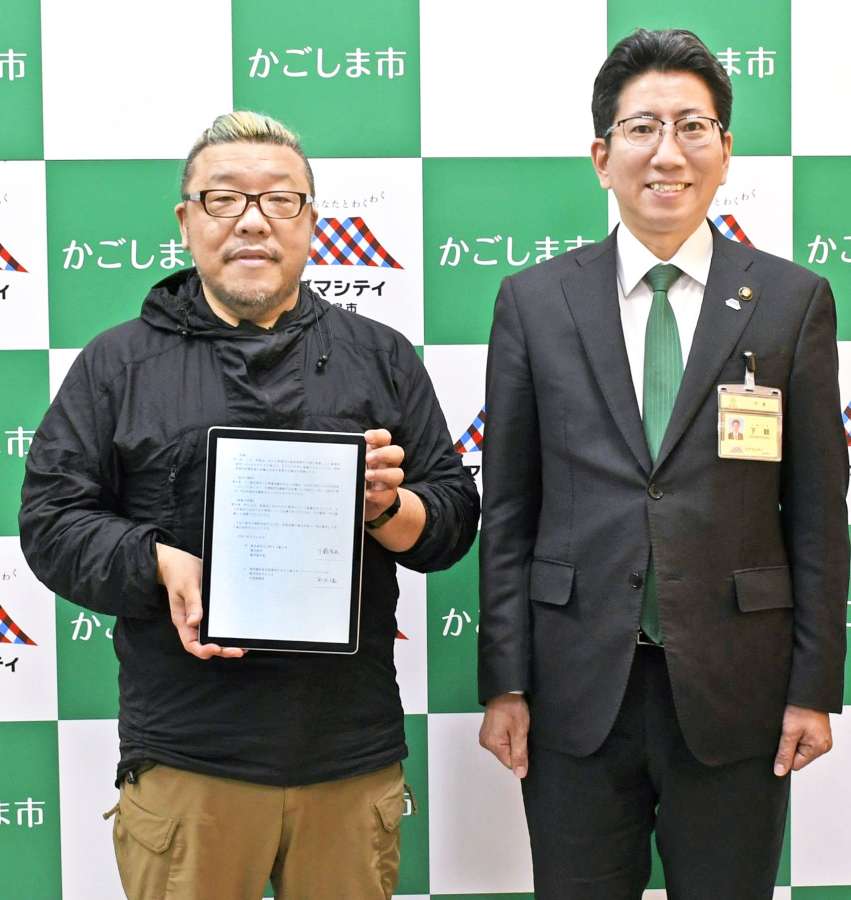 鹿児島市と立地協定を結んだサエッタの平沢久義社長（左）＝２６日、市役所（同市提供）