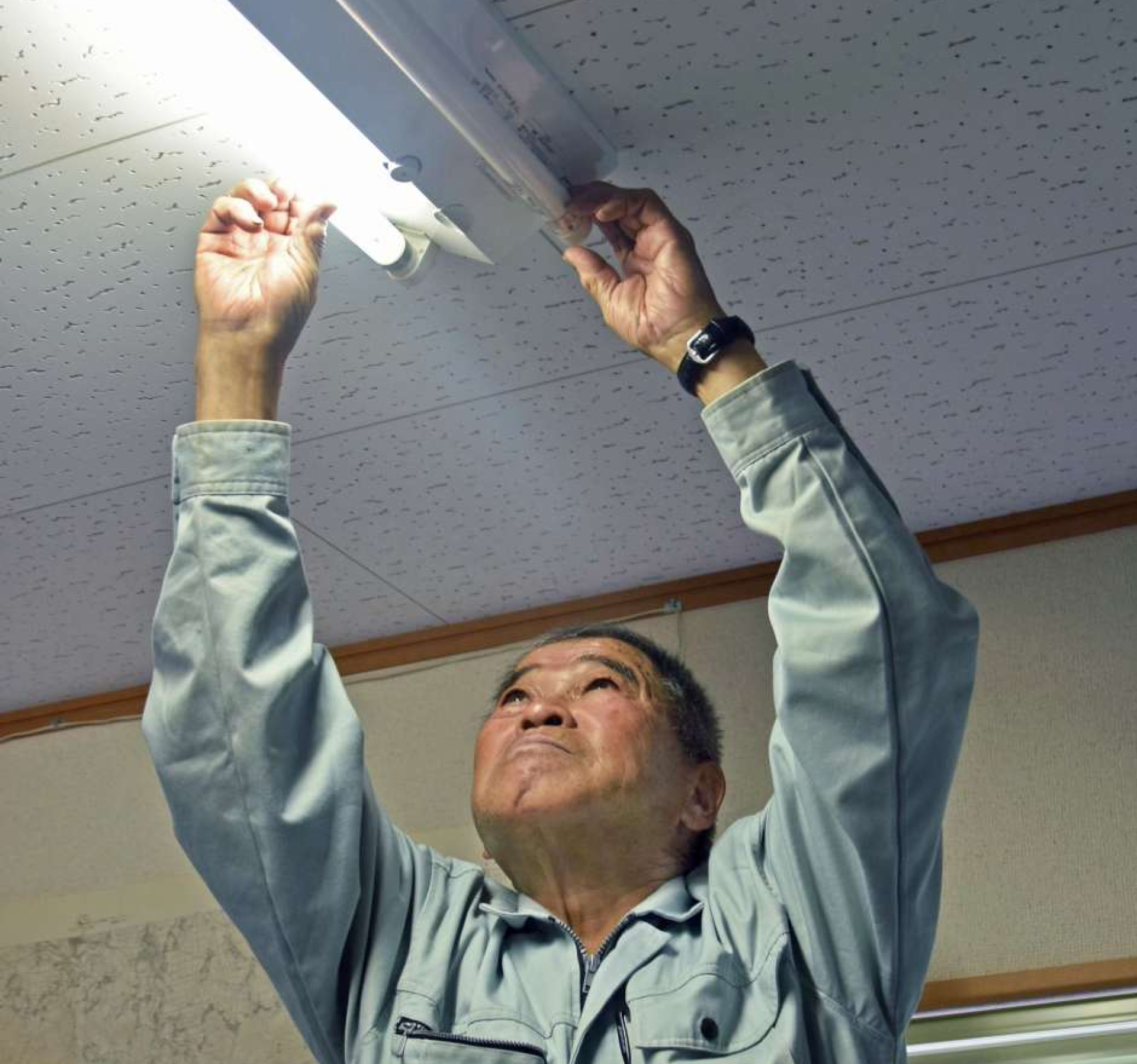 〈別カット〉電灯の取り換え作業をする船倉浩さん＝南大隅町根占
