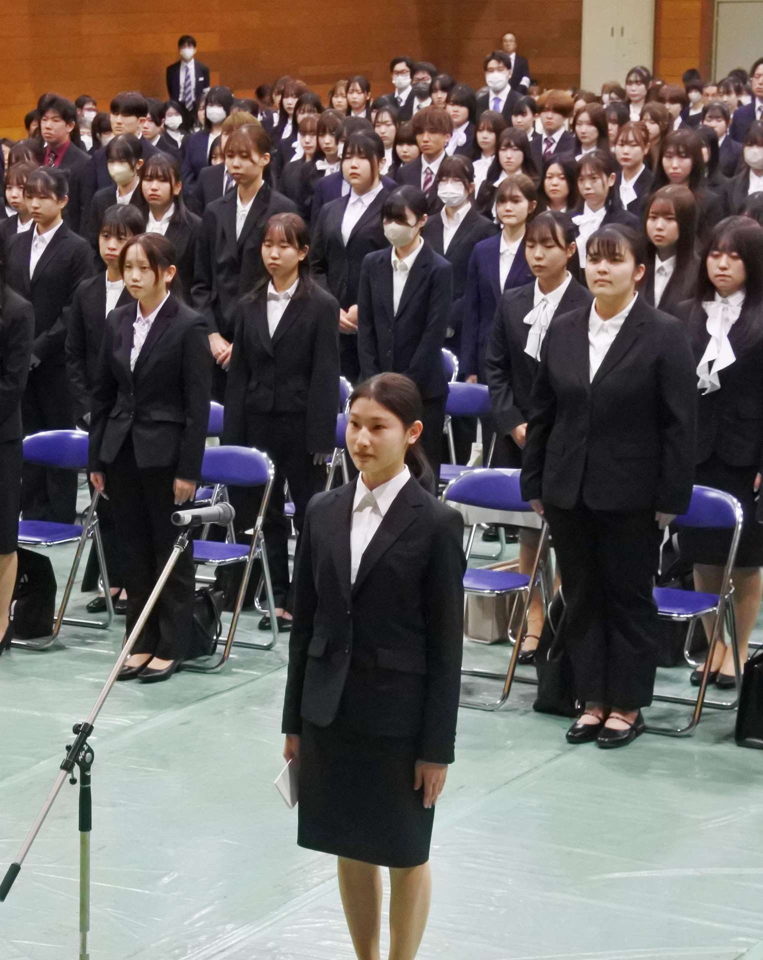 新入生を代表し、宣誓の言葉を述べる木田穂花さん（手前）＝８日、鹿児島市下伊敷１丁目の鹿児島県立短期大