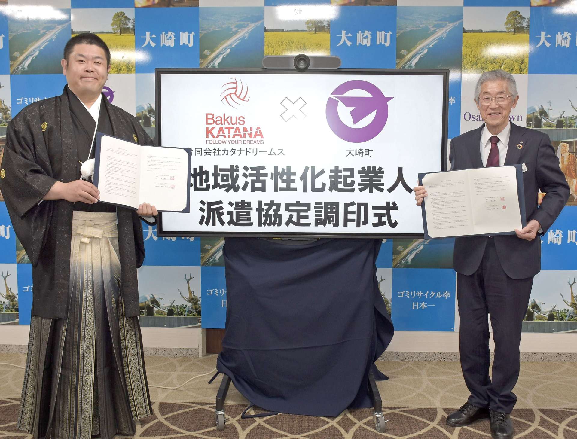 大崎町と職員派遣の協定を結んだカタナドリームスの栗崎純一代表（左）＝大崎町役場