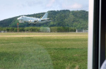 副滑走路に停まったバスから見えるＰ１哨戒機のローアプローチ〈動画あり〉＝２１日、鹿屋市の海上自衛隊鹿屋航空基地