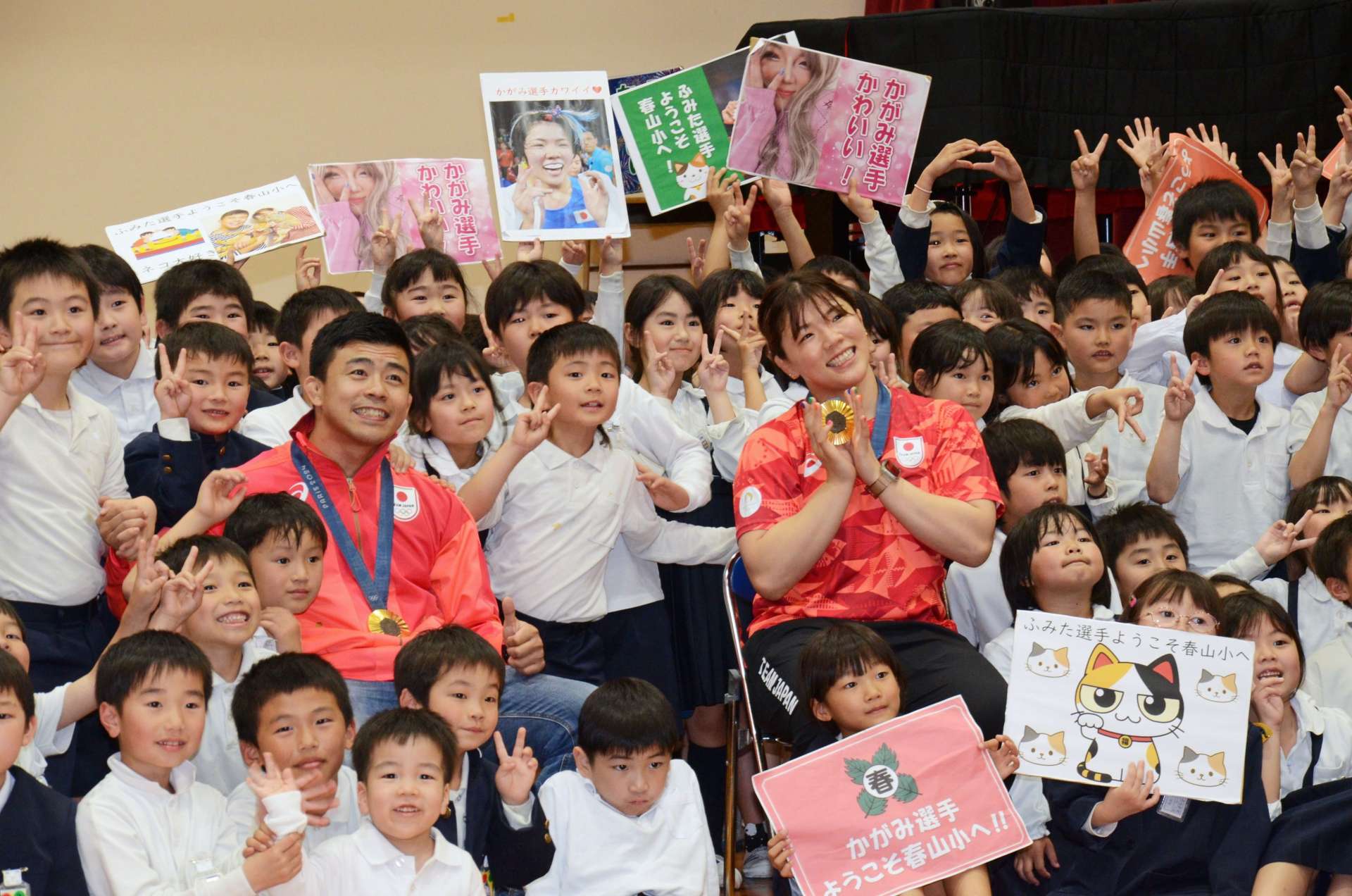 春山小学校の児童と交流を深めた文田健一郎、鏡優翔両選手＝鹿児島市の同校