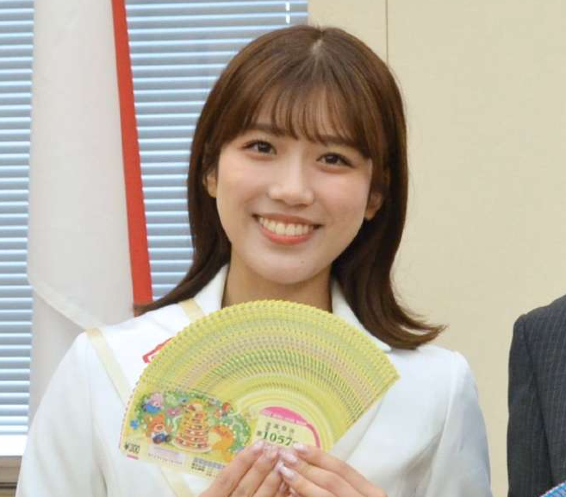 宝くじを手に笑顔を見せる幸運アンバサダーの松永鈴帆さん＝１３日、県庁