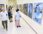 幅広い表現の作品に見入る来場者＝１７日、鹿児島市立美術館