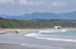 長い砂浜が続く脇本海岸。初夏はサーファーや潮干狩り客が訪れている＝阿久根市