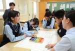 さつま町の通信簿をつける薩摩中央高校生＝さつま町虎居