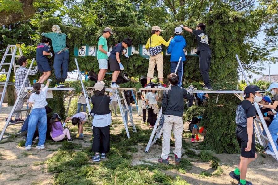 緑門作りに励む春山友の会のメンバーら＝５月３１日、鹿児島市の春山小学校