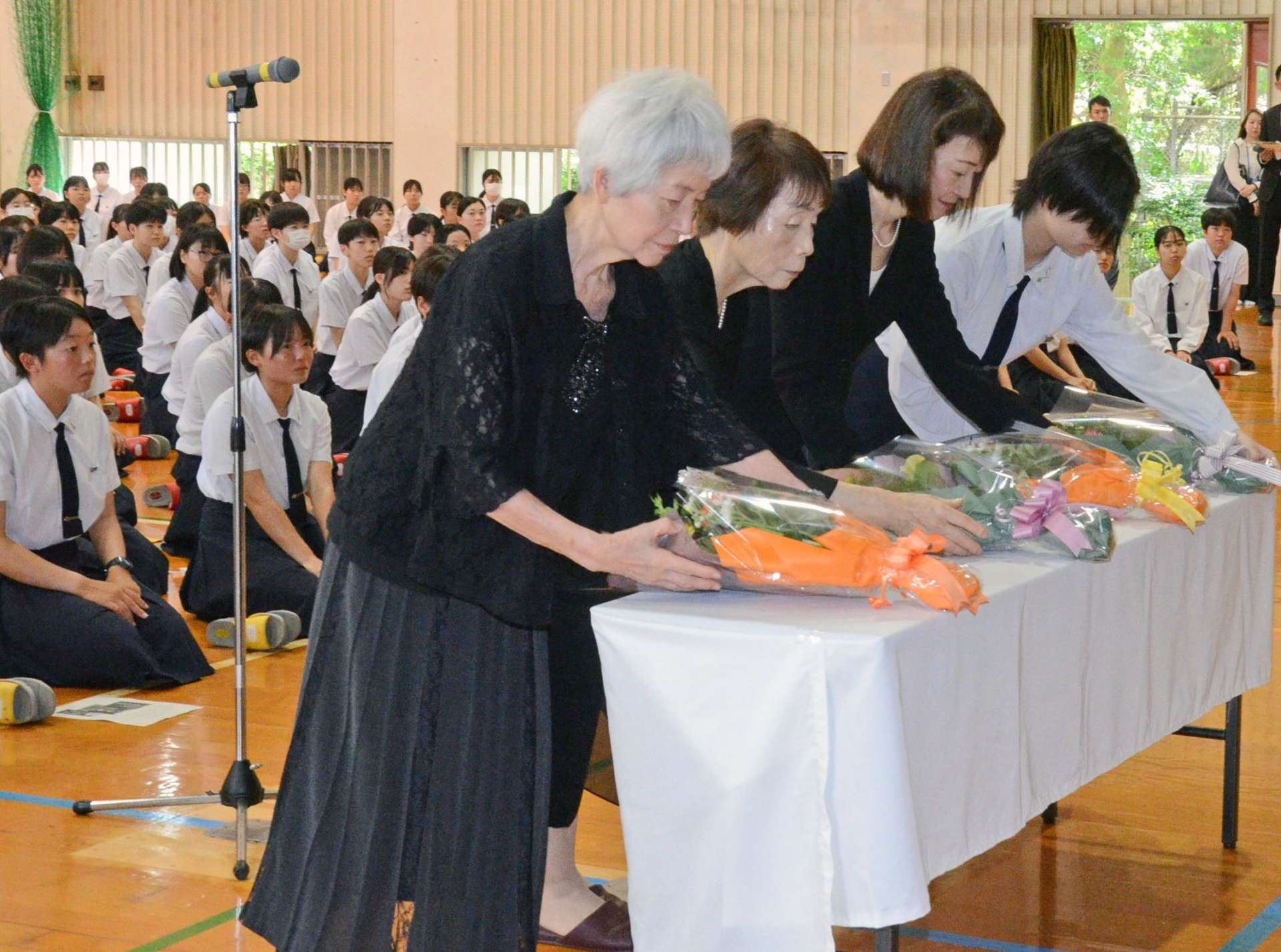 鹿児島大空襲の犠牲者を悼み献花する「帰厚会」会長ら＝１６日、鹿児島市玉里町の鹿児島市立女子高校
