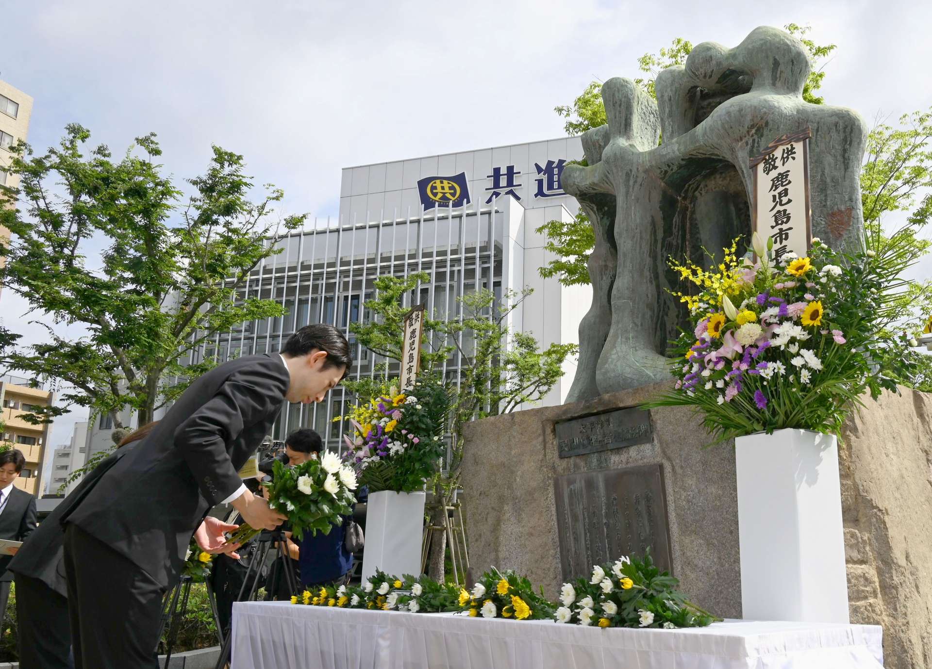 「人間之碑」に献花する参列者＝１７日、鹿児島市易居町