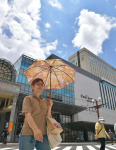 夏の日差しの下、日傘を差して歩く傘を手に歩く買い物客＝２７日午後０時２０分、鹿児島市の天文館