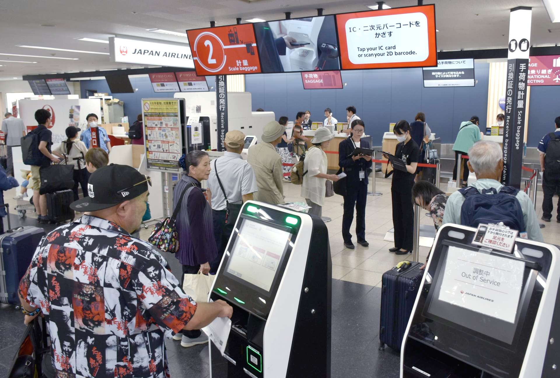 予定通り運航するか不安げに搭乗手続きに向かう乗客ら＝３日午後０時半、霧島市の鹿児島空港