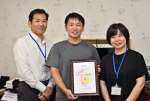 市から「あいさつ運動宣言団体」の登録証を受け取ったモン・シェリー松下の松下考太社長（中央）＝いちき串木野市のモン・シェリー松下
