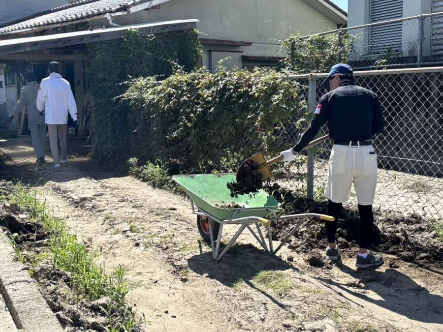 玄関先の泥をかき出すボランティア＝１９日午前１０時ごろ、霧島市隼人町姫城