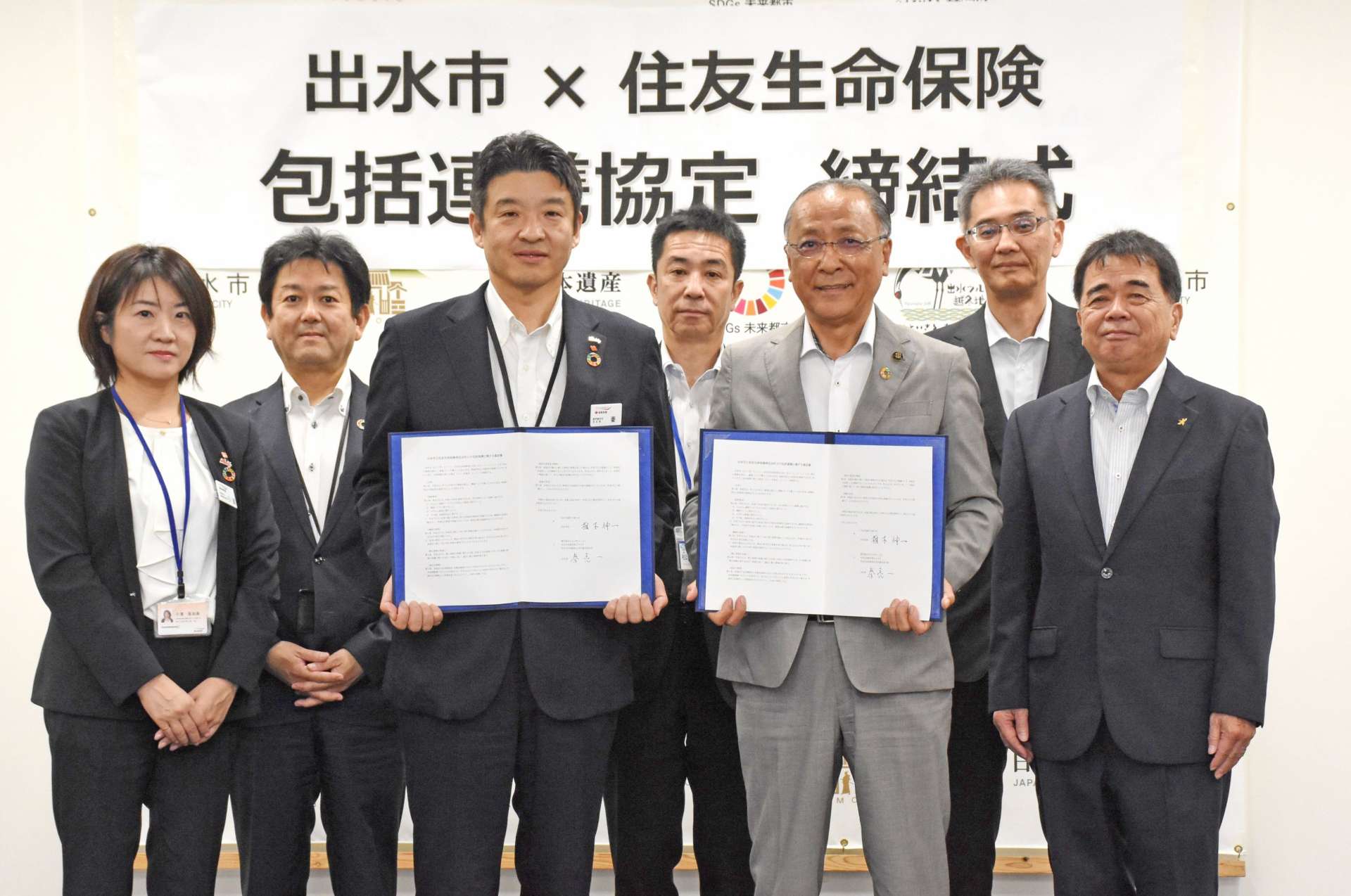 協定を結んだ秦亮一鹿児島支社長（中央左）と椎木伸一市長（同右）ら＝２０日、出水市役所