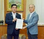 塩田康一知事（左）に県工業試験場跡地の利活用に関する提言書を手渡した検討委員会の井上佳朗委員長＝８日、県庁