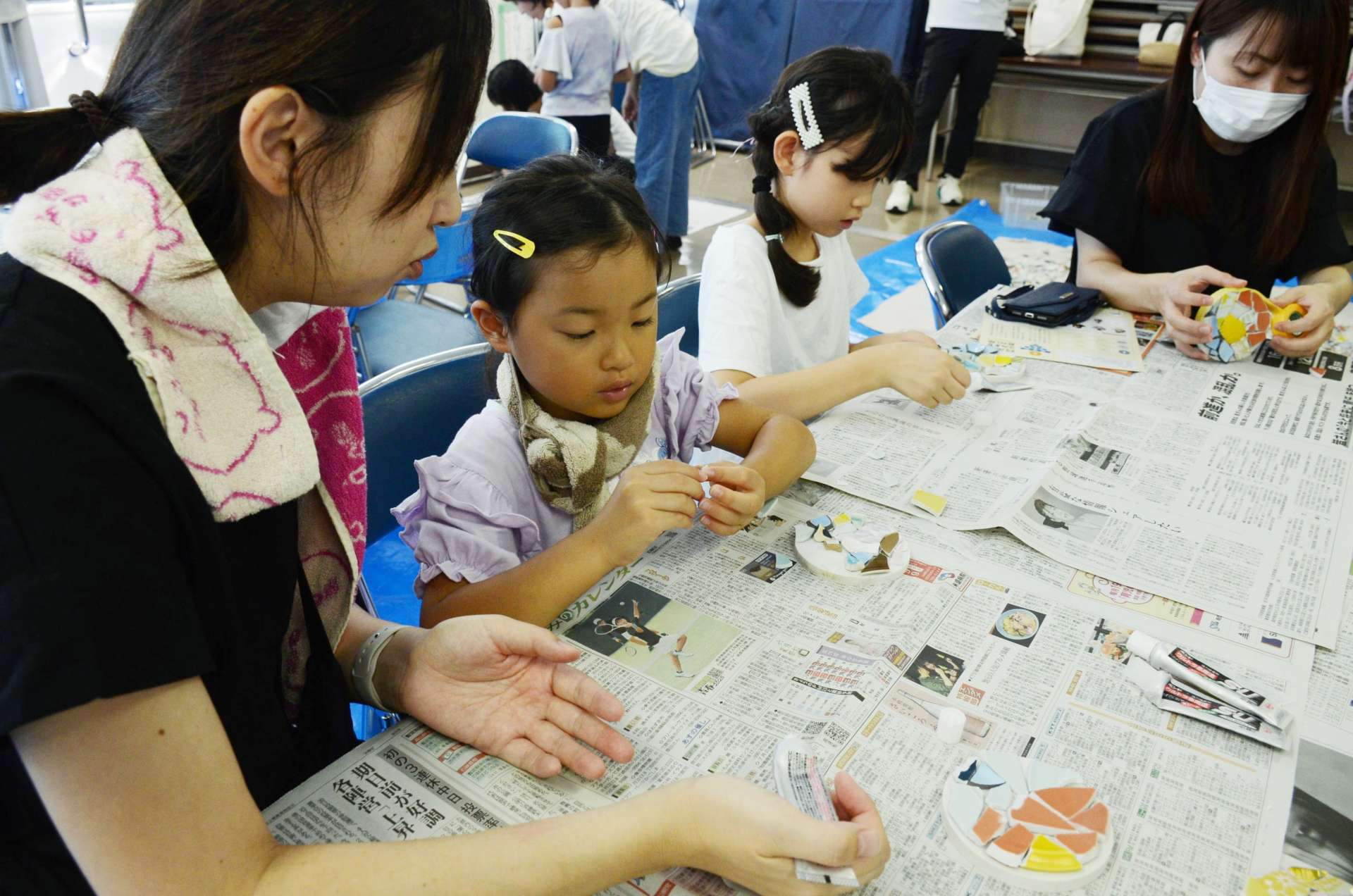 陶片を使ってモザイクタイル作りに挑戦する親子たち＝阿久根市中央公民館鶴見分館