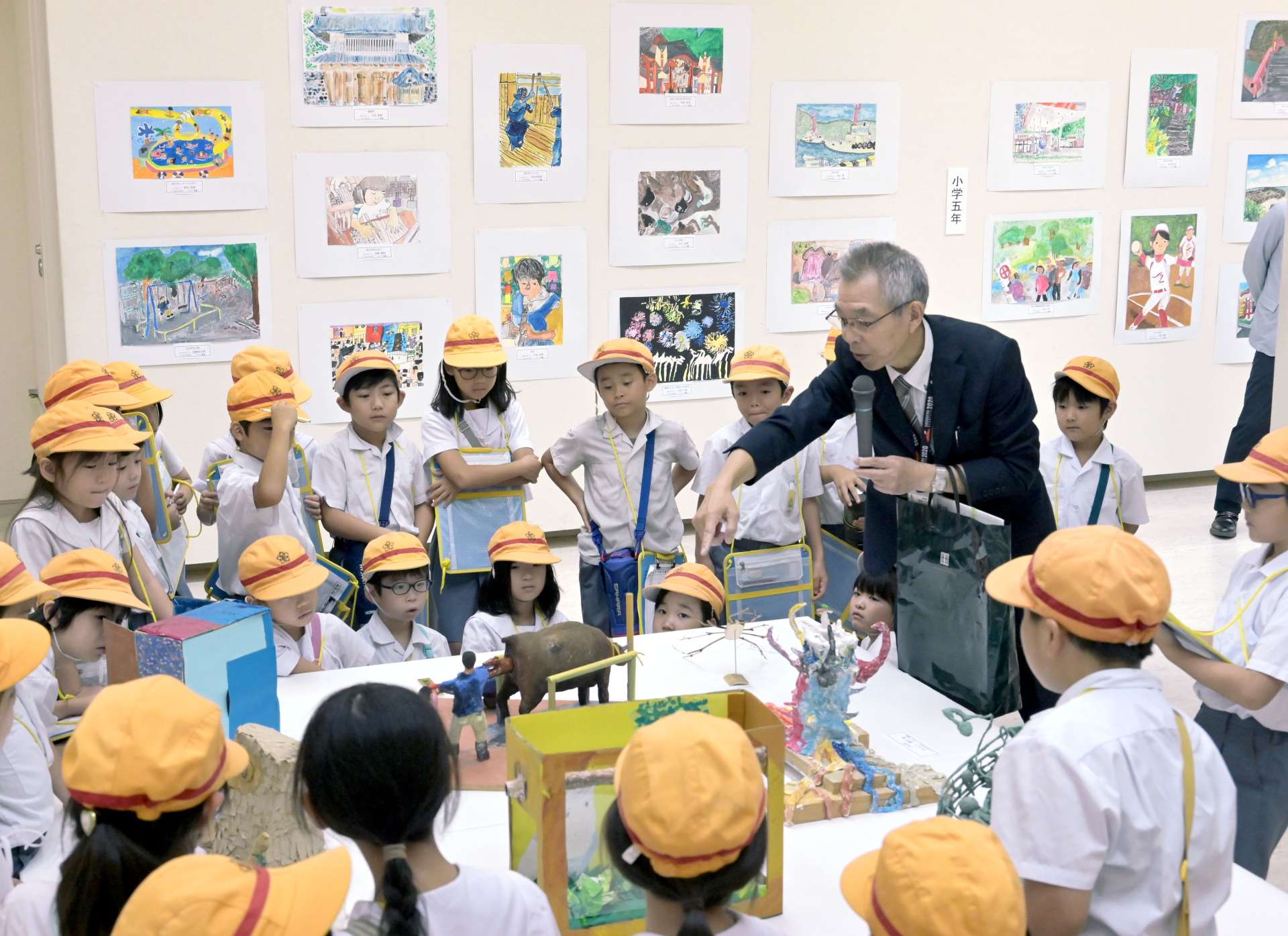 解説を聞きながら作品に見入る小学生＝１９日、鹿児島市立美術館（田中公人撮影）