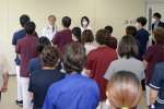 医療法人徳洲会による運営が始まり、朝礼に集まった職員ら＝１日、南種子町の公立種子島病院