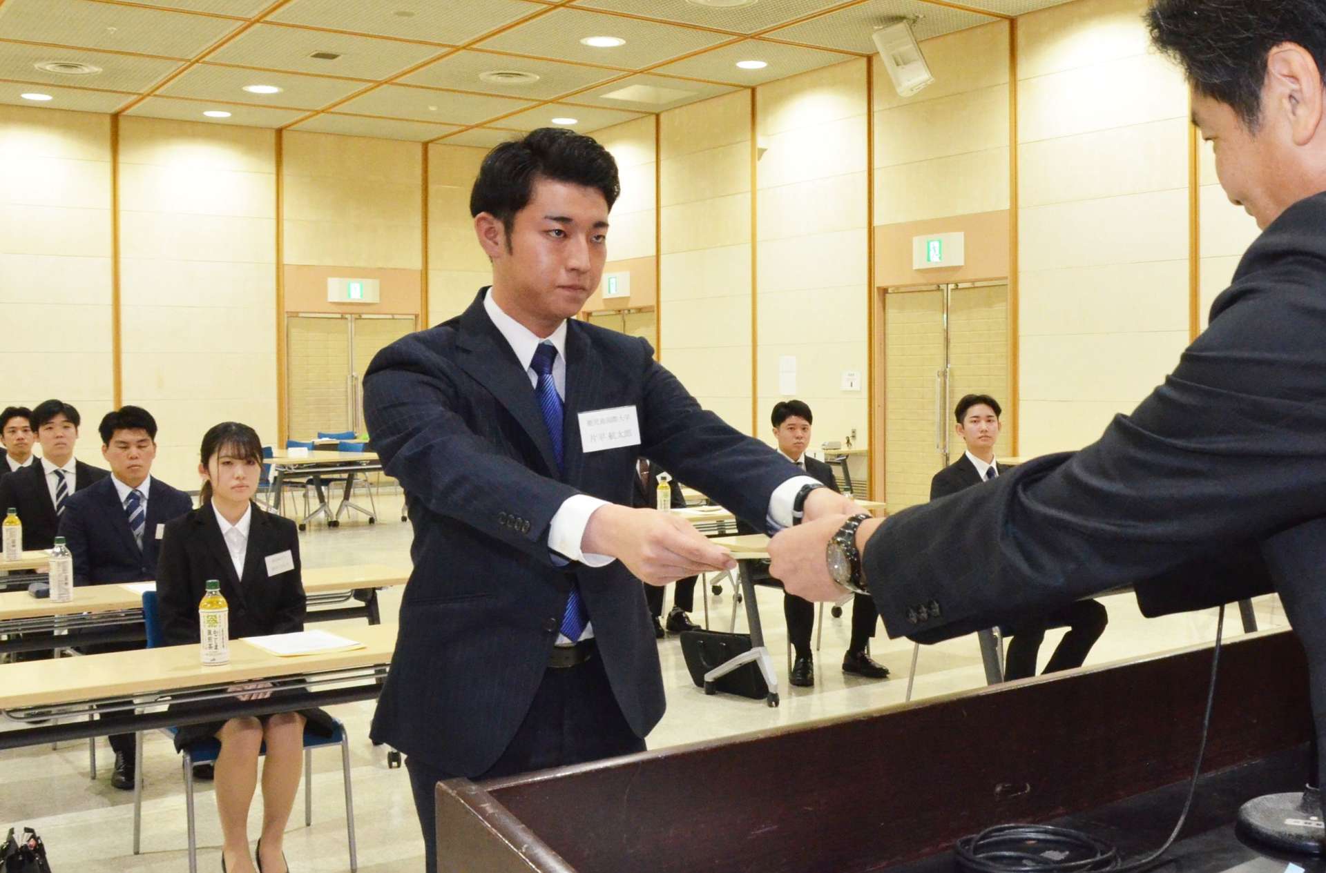 内定証書を受け取る内定者＝１日、鹿児島市のＪＡ県会館